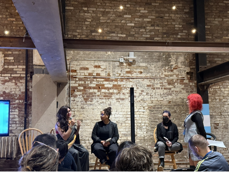 Manisha to the left with the microphone, speaking at ’Taking stock and holding the line: a cross-movement dialogue about bodily autonomy’ hosted by ILGA World, Count Me In!, European Sex Workers Alliance event